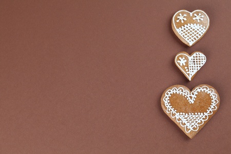 Gingerbread hearts on brown backgroundの写真素材