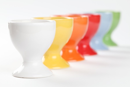 Close-up of a row of colorful eggcups. Shallow dof