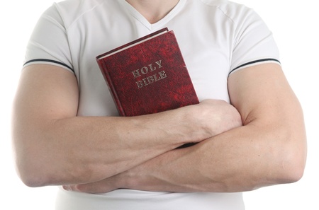 Man holding the Holy Bible, isolated on white background