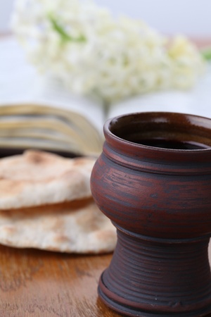 Holy communion - Chalice with red wine, pita bread, Holy Bible and white hyacinthの写真素材