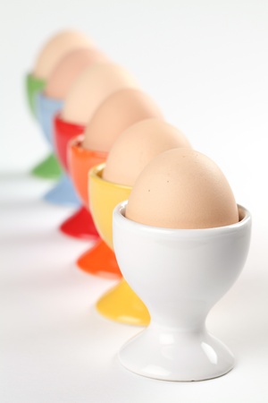 Colorful eggcups with brown chicken eggs  Shallow dofの写真素材