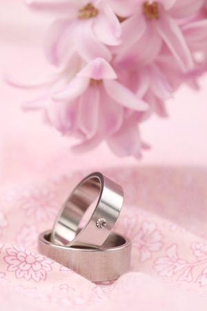 Titanium wedding rings on pink background with hyacinth  Shallow dofの写真素材