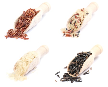 Wooden spoons with various kinds of rice on white backgroundの写真素材