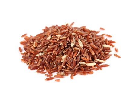 Close-up of a heap of red rice on white backgroundの写真素材