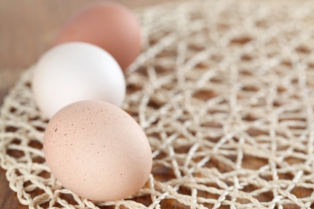Organic chicken eggs on a straw mat  Shallow dofの写真素材