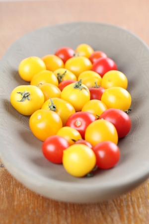Yellow and red cherry tomatoes in a bowl  Shallow dofの写真素材