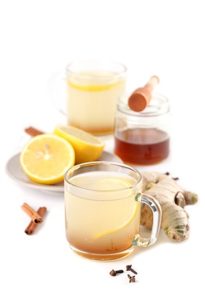 Ginger tea with honey, lemon, cinnamon and cloves isolated on white backgroundの写真素材