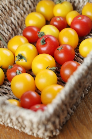 Yellow and red cherry tomatoes in a basket  Shallow dofの写真素材