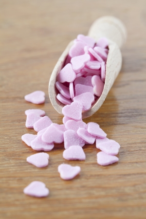 Little pink sugar hearts on a wooden spoon  Shallow dofの写真素材