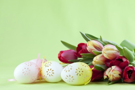 Flowery Easter eggs and red and yellow tulipsの写真素材