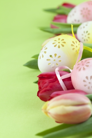 Border made from flowery Easter eggs and red and yellow tulipsの写真素材