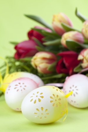 Flowery Easter eggs and red and yellow tulipsの写真素材