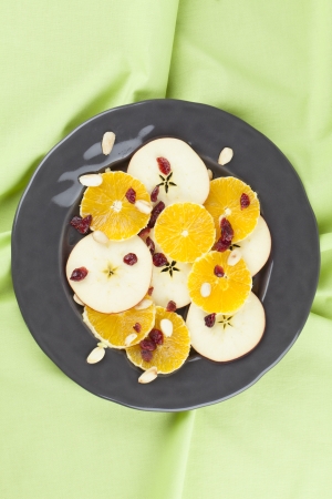 Healthy orange and apple salad with dried cranberries and roasted almondsの写真素材