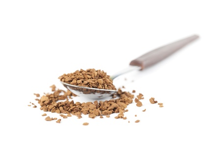 Instant coffee granules in a spoon isolated on white backgroundの写真素材