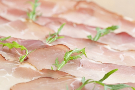 Prosciutto slices and arugula background  Shallow dofの写真素材