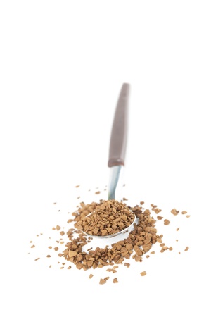 Instant coffee granules in a spoon isolated on white backgroundの写真素材