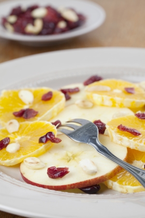 Healthy orange and apple salad with dried cranberries and roasted almondsの写真素材