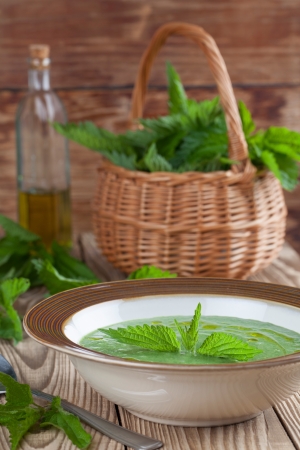 Nettle cream soup on wooden background  Shallow dofの写真素材