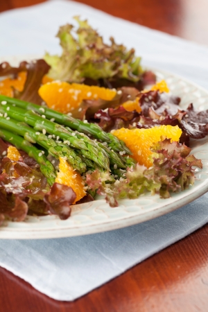 Asparagus salad with oranges, lollo rosso lettuce and hemp seedsの写真素材