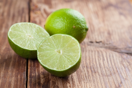 Limes on wooden background  Shallow dofの写真素材