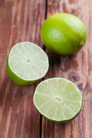 Limes on wooden background  Shallow dofの写真素材