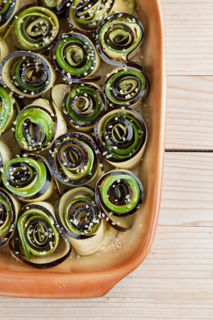 Eggplant and zucchini rolls on baking sheet with hemp seedの写真素材