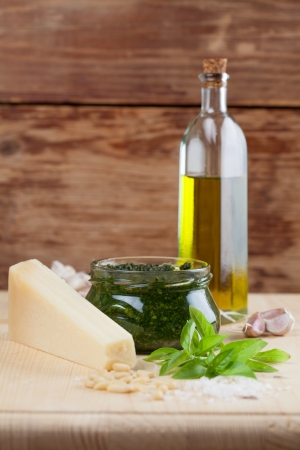 Freshly made pesto with ingredients on wooden boardの写真素材