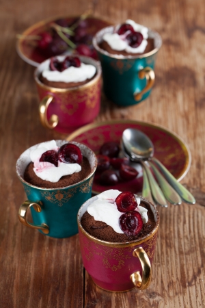 Raw vegan avocado chocolate mousse with cherries and coconut whipped creamの写真素材