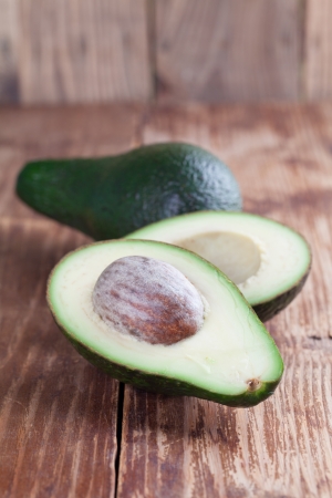 Two avocados on wooden tableの写真素材