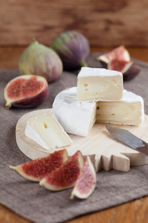 Camembert and fresh figs on a cutting boardの写真素材