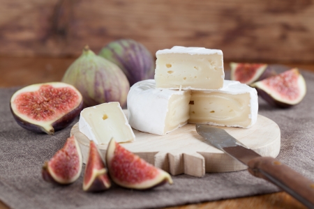 Camembert and fresh figs on a cutting boardの写真素材