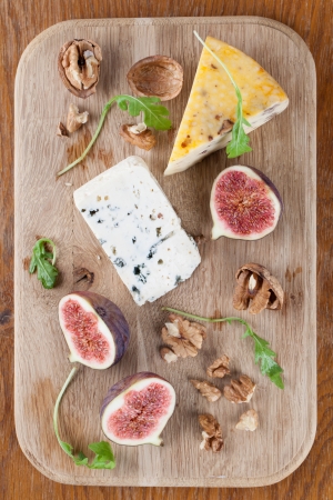 Cheese board with blue cheese, nut cheese, fresh figs and nutsの写真素材