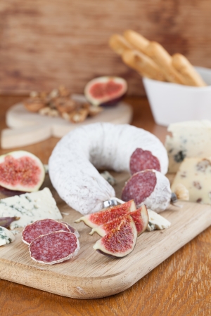 Meat with cheese, figs, nuts and grissiniの写真素材