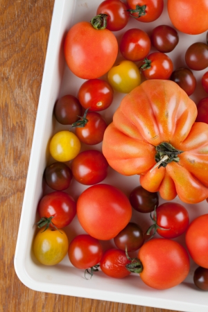 Yellow, red and black tomatoes on baking sheetの写真素材