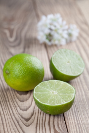 Limes on wooden tableの写真素材