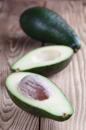 Two avocados on wooden tableの写真素材