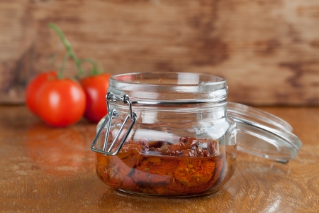 Sun dried tomatoes with olive oil in a jarの写真素材