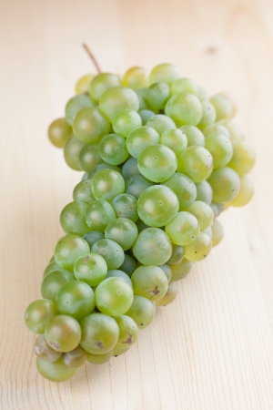 Green grape cluster on wooden の写真素材