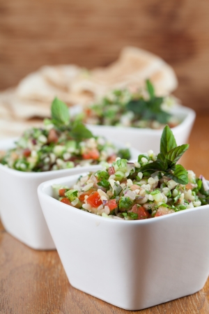 Gourmet Middle Eastern salad Tabbouleh in white bowlsの写真素材