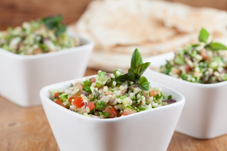 Gourmet Middle Eastern salad Tabbouleh in white bowlsの写真素材