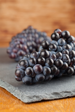 Blue grape clusters on slate board  Shallow dofの写真素材