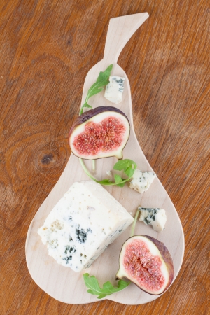 Blue cheese and fresh figs on a cutting boardの写真素材