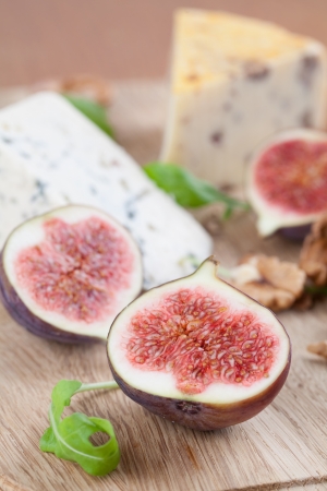 Cheese board with blue cheese, nut cheese, fresh figs and nutsの写真素材