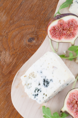 Blue cheese and fresh figs on a cutting boardの写真素材
