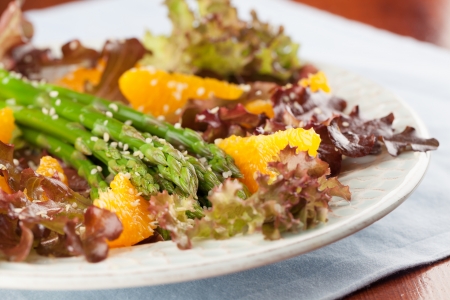Asparagus salad with oranges, lollo rosso lettuce and hemp seedsの写真素材