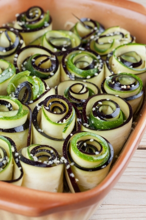Eggplant and zucchini rolls on baking sheet with hemp seedの写真素材