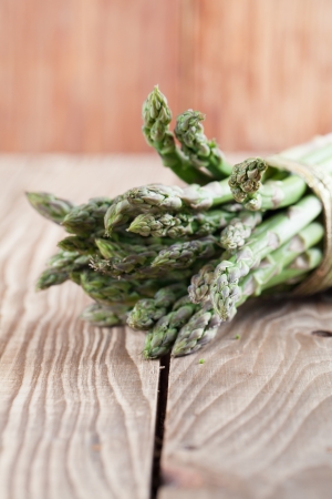 Bunch of fresh green asparagus on wooden の写真素材