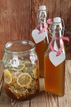 Making elderberry syrup with lemons and cane sugar, alternative medicine for cough, cold or flu.の写真素材