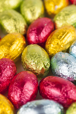 Background made from colorful chocolate Easter eggsの写真素材