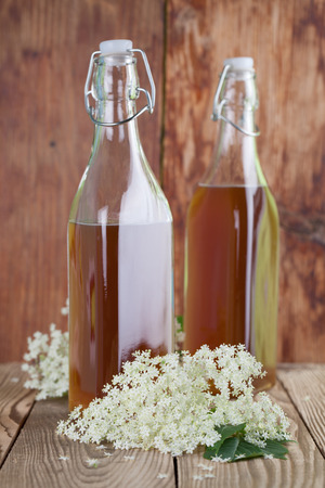 Bottles with freshly made elderberry syrup, alternative medicine for cough, cold or flu の写真素材